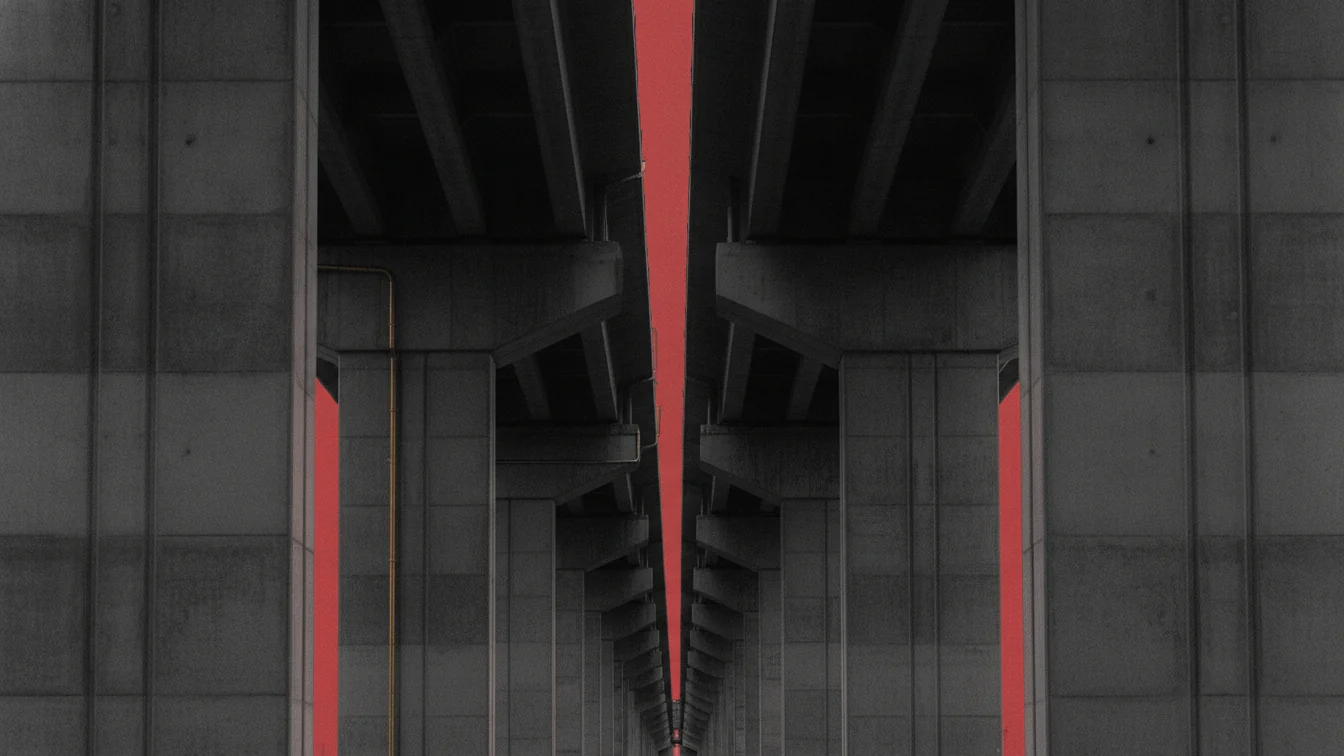 Dessous d'un viaduc en béton, files de piles fuyant vers l'horizon